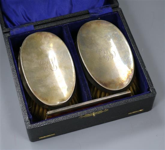 A cased three piece silver brush and comb set.